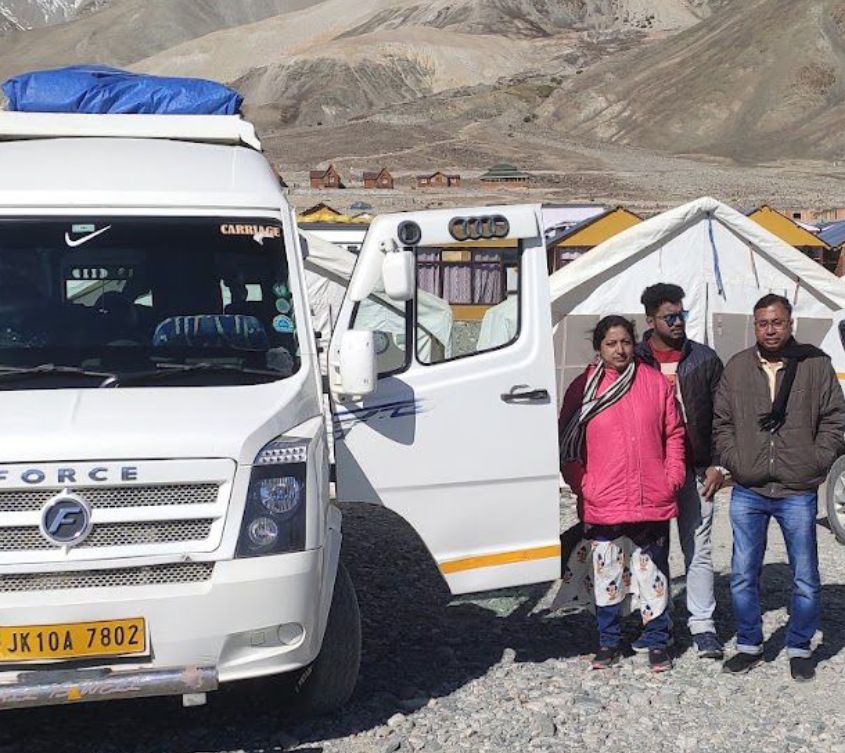 A joyful group of travelers posing together amid the stunning landscapes of Kashmir and Leh–Ladakh during their Odyssey Travels tour. The photo captures the spirit of togetherness, scenic beauty, and excellent travel arrangements that made the trip truly unforgettable.