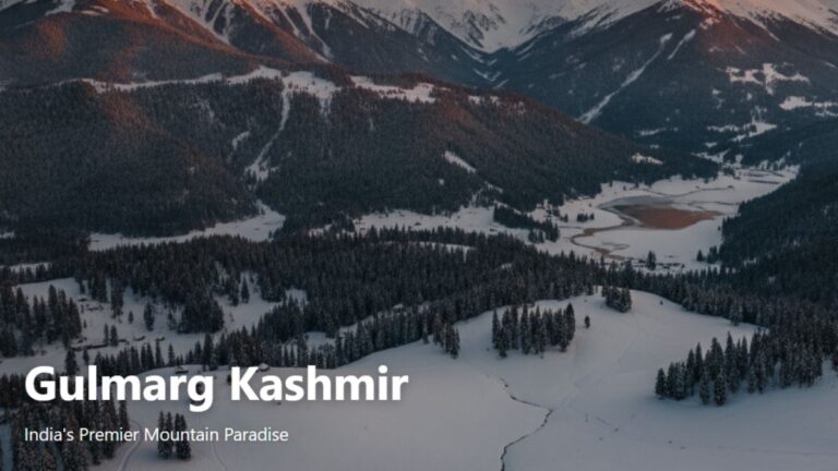 Panoramic view of Gulmarg in Kashmir, India, featuring snow-covered mountains, pine forests, and green valleys under a clear blue sky.
